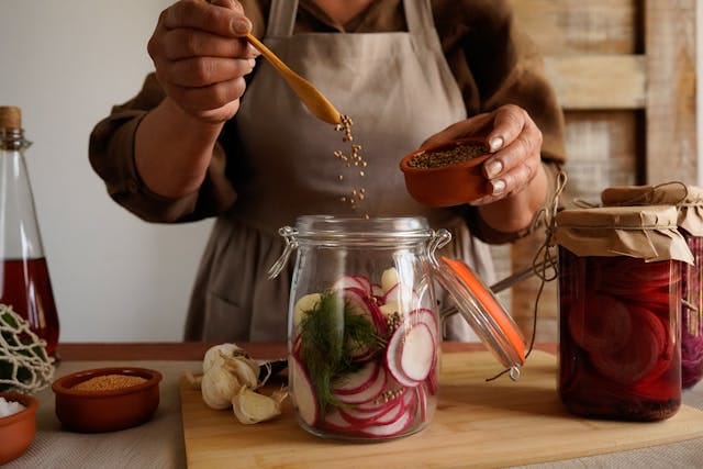 A Women Preparing Pickle in a Jar